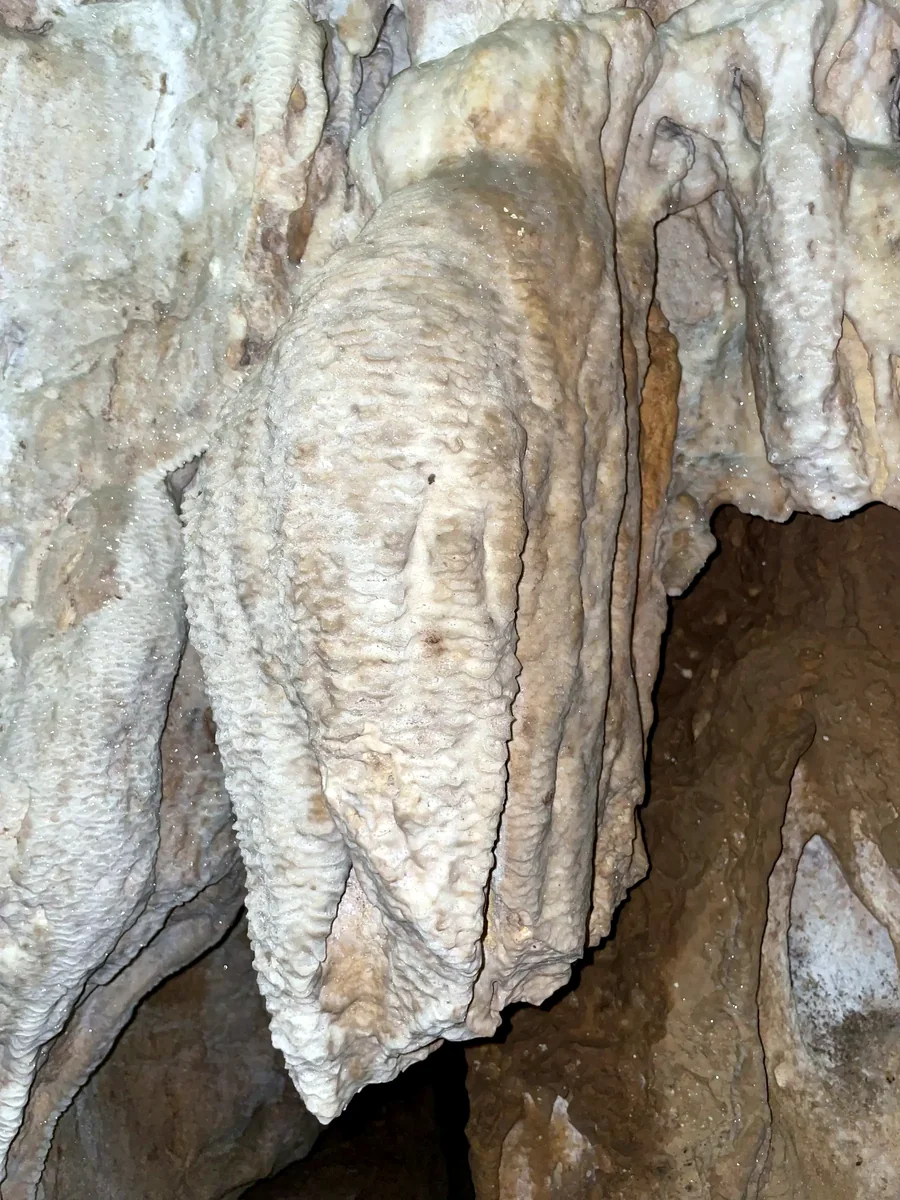 Pendant calcite deposit on a cave wall